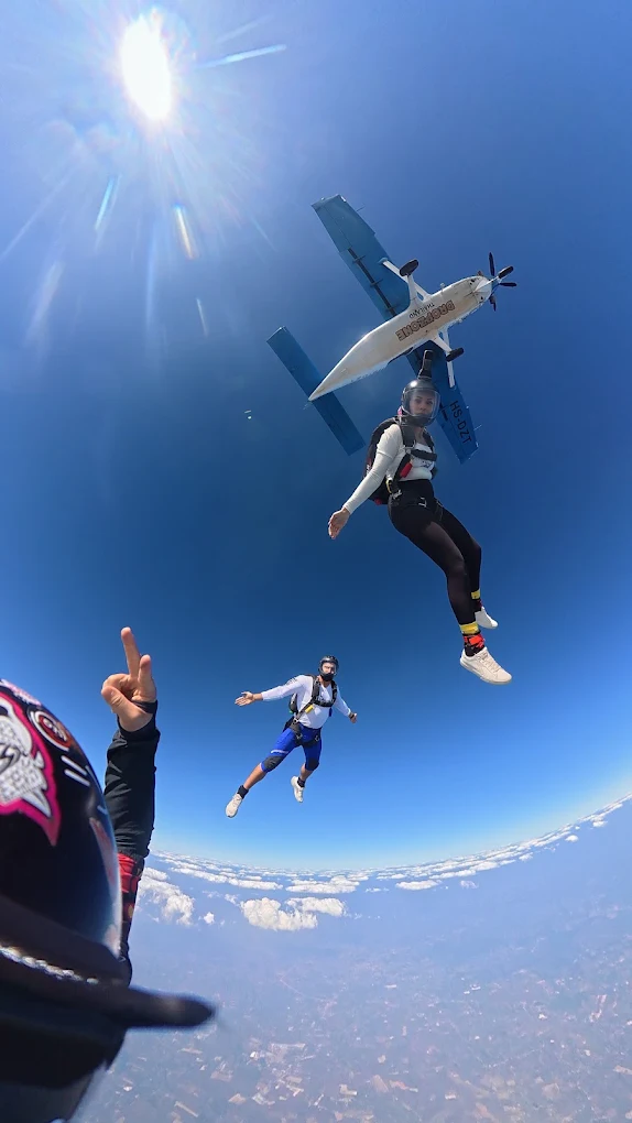 Licensed skydivers leaving the aircraft over the sea
