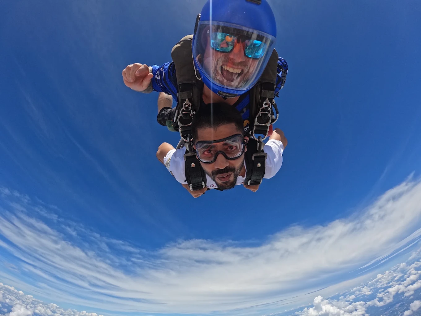 Tandem pair in freefall above the sea